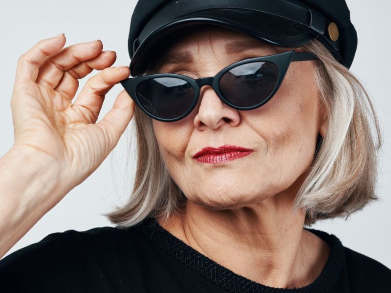 Colours By Kathy - Mature lady wearing black hat, sunglasses and red lipstick